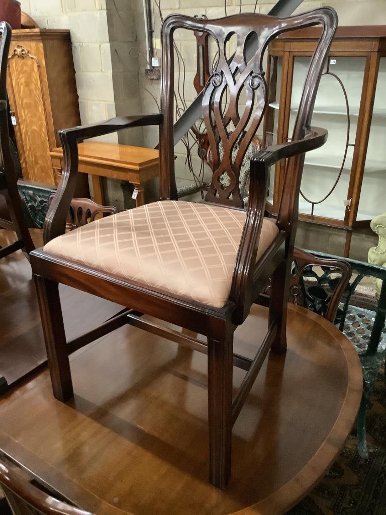 A George III style D-end twin-pedestal dining table and a set of eight George III style mahogany dining chairs, two with arms, table width 245cm extended (two spare leaves)